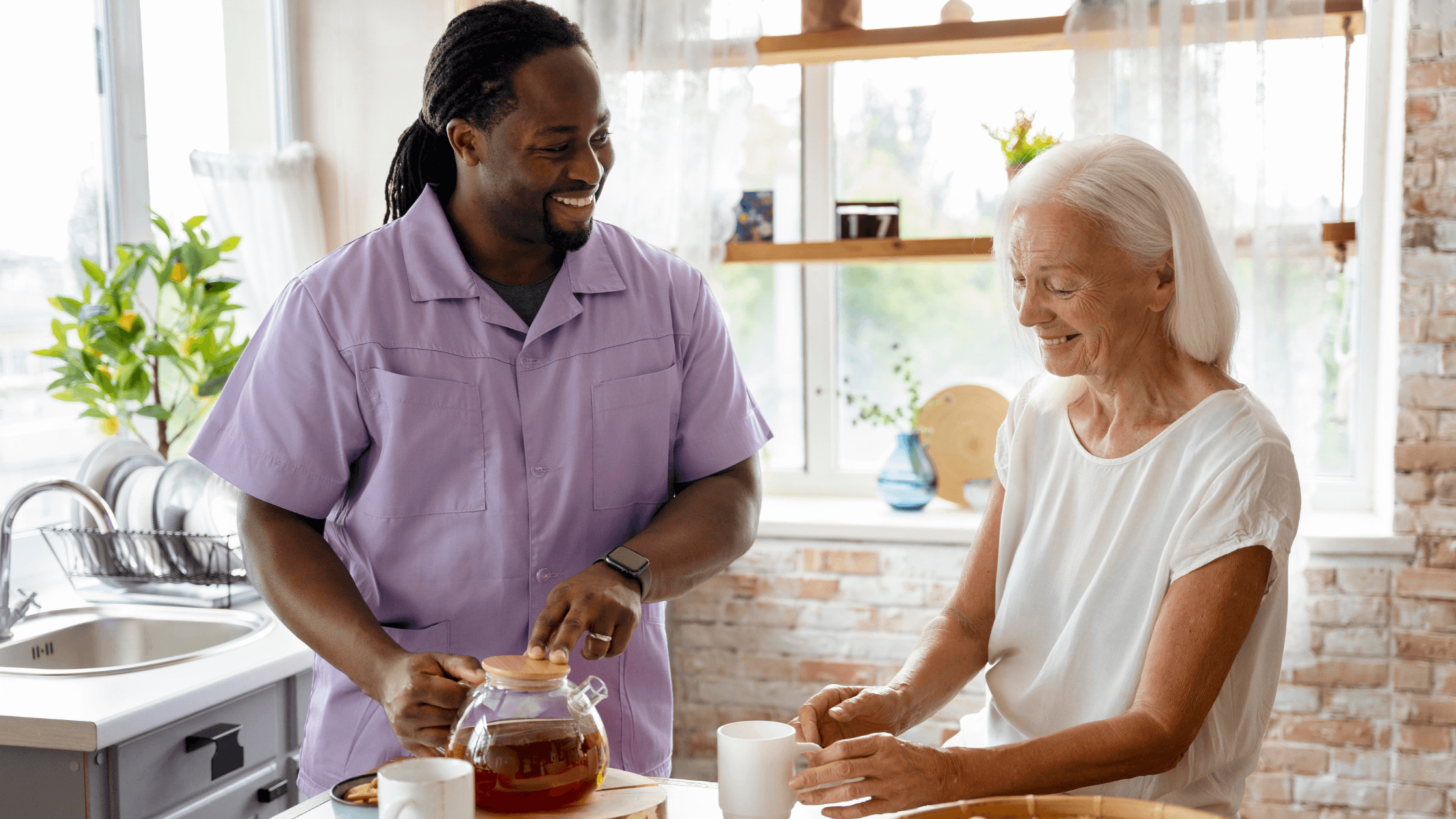 man of color caregiver with senior woman standing holding mug